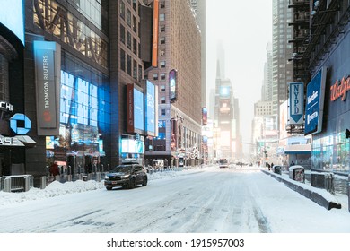 New York City, New York USA - February 13 2021: Snowy Times Square. Snowy Streets Of Manhattan. Streets Of NYC. Winter In New York. Urban Life Of NYC. Manhattan Urban Winter Scenery.