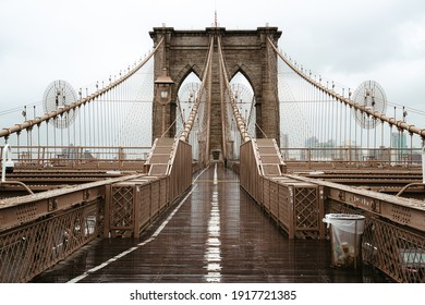New York City, New York USA - February 16 2021: Brooklyn Bridge in new York. Grey big bridge. Old architecture of NYC. Brooklyn Bridge close up view. Iconic American construction in New York.