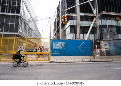 New York City, New York, USA - Jan 14th 2014: A Man Riding A Bike In Front Of The Construction Site Of 911 Memorial 