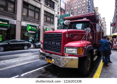 New York City, USA - July 25, 2018: Truck Driver Resting In A Red Trailer Of The Mack Brand In Manhattan In New York City, USA