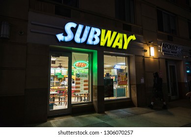 New York City, USA - July 27, 2018: Subway Restaurant At Night With A Man Walking In Harlem, Manhattan, New York City, USA