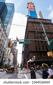 New York City, USA - July 28, 2018: Horse Carriage In Seventh Avenue With People Around And A Smoke Stack Steam Pipe In Manhattan, New York City, USA