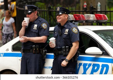 NEW YORK CITY , USA - JULY 07, 2015: Two Police Officers While Drinking A Cup Of Coffee. NYPD, Established In 1845, Is The Largest Municipal Police Force In The United States.