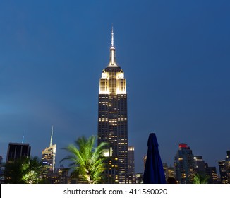 New York City, USA - July 13, 2015: View of the famous Empire State Building at sunset. This view is from the rooftop of the 230-fifth Bar.