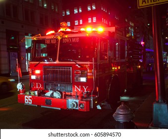 New York City, Usa - July 11, 2015: Fire Engine Of FDNY Engine Company 65 With Lights Flashing At Night In Midtown Manhattan.