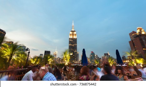 New York City USA - July 13 2015: View of the famous Empire State Building at sunset. This view is from the rooftop of the 230-fifth Bar.