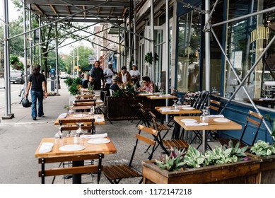 New York City, USA - June 22, 2018:  Sidewalk Cafe With People Enjoying In Greenwich Village