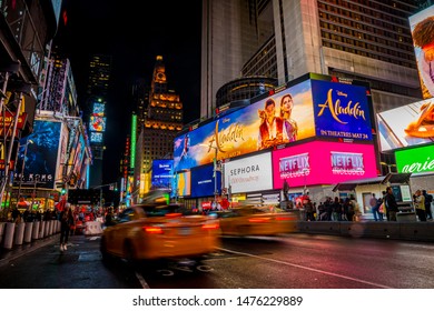 NEW YORK CITY, USA - June 20, 2019: Cars, Traffic And People Crowd Rushing At Times Square At Night. Panoramic Time Lapse.