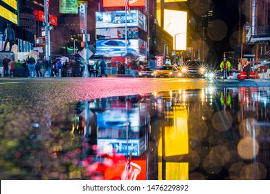 NEW YORK CITY, USA - June 20, 2019: Cars, Traffic And People Crowd Rushing At Times Square At Night. Panoramic Time Lapse.