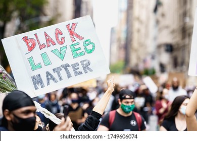 New York City, New York / USA - June 5 2020. Protests in New York. People with protesting posters marching protest over George Floyd death. Black lives matter movement in New York. 
