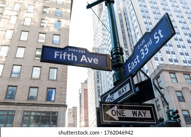 New York City, New York / USA - June 23 2020: New York street pedestrian direction sign. Street name signs in Manhattan. Building sign.  Manhattan streets. Empty streets of New York.