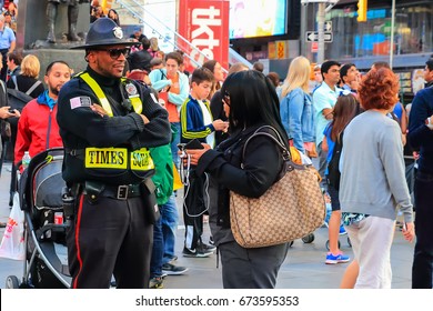 New York City, USA - June 7, 2017: Times Square Alliance Public Safety Officer Attending To A Tourist