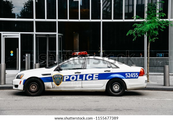 New York City, USA - June 20,\
2018: Port Authority Police car parked in front of office\
building