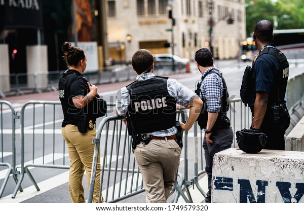 New York City, New York / USA - June 5 2020.\
Police guarding New York property because of looting and rioting\
protests over George Floyd death. Police and protesters in\
Manhattan. Police\
brutality.
