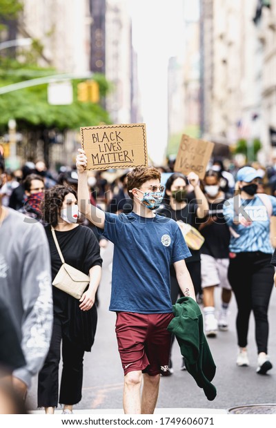 New York\
City, New York / USA - June 5 2020. Protests in New York. People\
with protesting posters marching protest over George Floyd death.\
Black lives matter movement in New York.\
