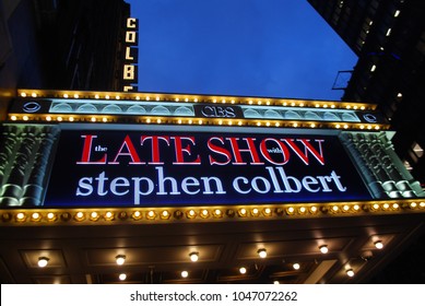 New York City, USA - March 10 2018: Manhattan NYC Buildings In Times Square, Broadway Street Avenue Road, Signs For Colbert Late Show, Angelo's Pizza Italian Restaurant, Marquee / Theatre At Night