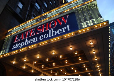 New York City, USA - March 10 2018: Manhattan NYC Buildings In Times Square, Broadway Street Avenue Road, Signs For Colbert Late Show, Angelo's Pizza Italian Restaurant, Marquee / Theatre At Night