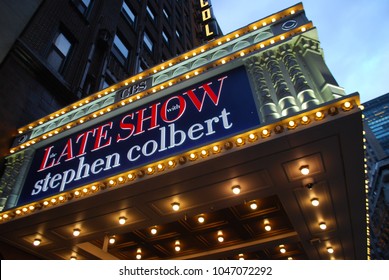 New York City, USA - March 10 2018: Manhattan NYC Buildings In Times Square, Broadway Street Avenue Road, Signs For Colbert Late Show, Angelo's Pizza Italian Restaurant, Marquee / Theatre At Night