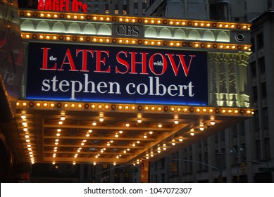 New York City, USA - March 10 2018: Manhattan NYC Buildings In Times Square, Broadway Street Avenue Road, Signs For Colbert Late Show, Angelo's Pizza Italian Restaurant, Marquee / Theatre At Night