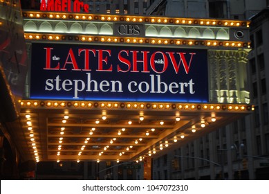 New York City, USA - March 10 2018: Manhattan NYC Buildings In Times Square, Broadway Street Avenue Road, Signs For Colbert Late Show, Angelo's Pizza Italian Restaurant, Marquee / Theatre At Night