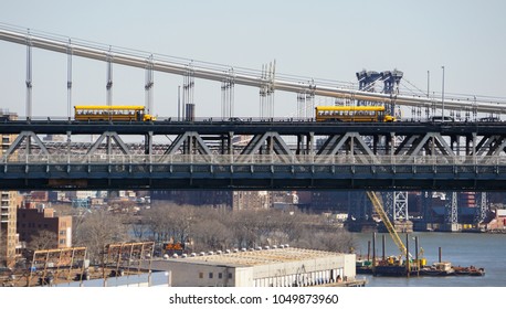New York City / USA - March 2018: Two yellow american School buses on Manhattan Bridge.