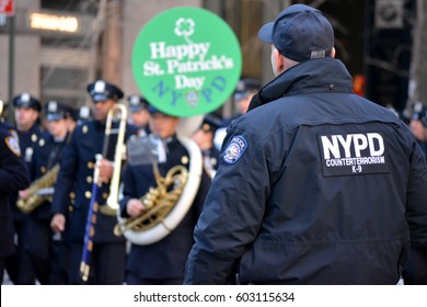 New York City, USA - March 17, 2017: NYPD Counter Terrorism Officer Watching The NYPD Marching Band As It Marches In The St. Patrick's Day Parade In Midtown Manhattan In New York City. 