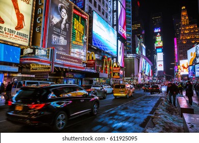 New York City, USA- March 18, 2017: Times Square, featured with Broadway Theaters and animated colorful LED signs, stores, and lots of tourists and locals, is a symbol of NYC and the USA in Manhattan.