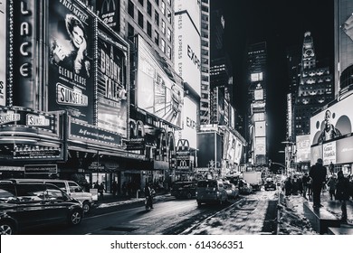 New York City, USA- March 18, 2017: Times Square, featured with Broadway Theaters and animated colorful LED signs, stores, and lots of tourists and locals, is a symbol of NYC and the USA in Manhattan.
