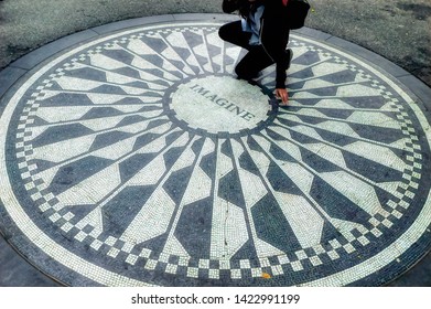 NEW YORK CITY, USA, May 30 2017: Circular pathway mosaic of inland stones with a single word, the title of famous song Imagine, at Dakota in Central Park in New York City, USA.