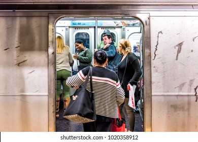 New York City, USA - October 28, 2017: People In Underground Platform Transit In NYC Subway Station On Commute With Train, People Crammed Crowd With Open Closing Doors, Woman Entering