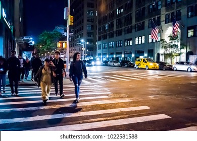 New York City, USA - October 28, 2017: NYC Downtown Dark Evening Night Illuminated Charlton Street Road With Traffic Cars, People Crossing Sidewalk In SoHo, Hudson Square Neighborhood