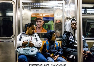 New York City, USA - October 28, 2017: Family People With Children Sitting On Chairs In Subway Train Car Looking In Transit In NYC Morning