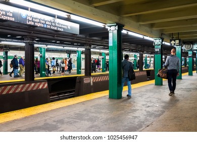 New York City, USA - October 28, 2017: People Walking Standing Waiting In Underground Transit Empty Large Platform In NYC Subway Station, Exit Sign At Washington Square Platform