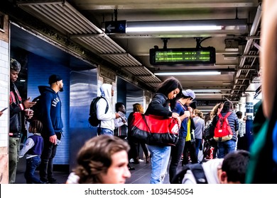 New York City, USA - October 28, 2017: People Waiting In Underground Transit Empty Large Platform In NYC Subway Station In Downtown, Looking At Phones On Fulton Street