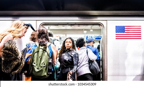 New York City, USA - October 28, 2017: People In Underground Platform Transit In NYC Subway Station On Commute With Train, People Crammed Crowd With Open Closing Doors, Woman Exiting, Boarding