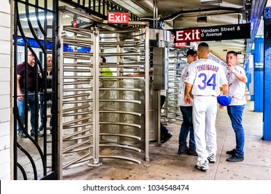 New York City, USA - October 28, 2017: Subway Station Entrance With People In Underground Transit In NYC, Spring Vandam Street Sign Exit At Turnstile, Group Of Guys At Halloween