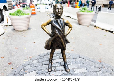 New York City, USA - October 30, 2017: Wall Street stock exchange The Fearless Girl statue facing Charging Bull metal in NYC Manhattan lower financial district downtown, nobody closeup NYSE
