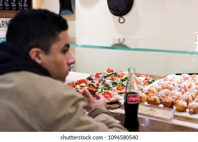 New York City, USA - October 30, 2017: Market Food Shop Interior Man Eating Inside In Downtown Lower Chelsea Neighborhood District Manhattan NYC, Filaga Pizza Store, Cafe, Restaurant, Pizzeria