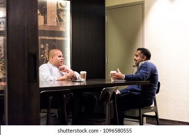 New York City, USA - October 30, 2017: Inside Starbucks Store In Midtown Manhattan NYC NY With People Work Colleagues Talking Over Food, Coffee In Cafe Sitting At Table