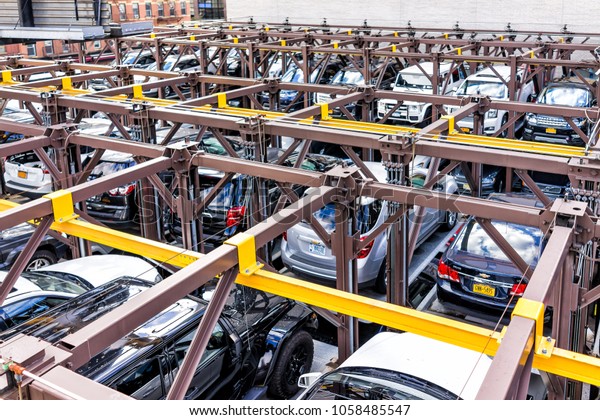 New\
York City, USA - October 30, 2017: Aerial view of Chelsea\
neighborhood parked cars parking lot outdoor organized garage on\
street below in New York, Manhattan, NYC,\
elevated