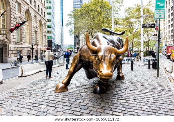 New York City, USA -\
October 30, 2017: Wall Street stock exchange charging metal bull in\
NYC Manhattan lower financial district downtown NYSE, closeup of\
face