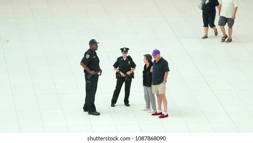 NEW YORK CITY, USA - September 20, 2017- Police Speaking To Bystanders From Afar. Cops Talking To People While Safeguarding Protection