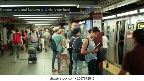 NEW YORK CITY, USA - September 20, 2017- NYC Subway Trains, People Waiting At New York City Platform