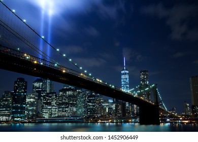 New York City, USA - September 11, 2014: Brooklyn bridge with Tribute in Light . The installation of 88 searchlights has been displayed annually in remembrance of the September 11, 2001 attacks.