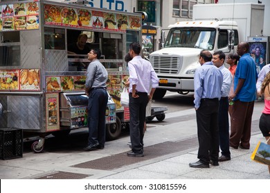 NEW YORK CITY, USA - SEPTEMBER, 2014: Businessmen During Lunch At Food Cart