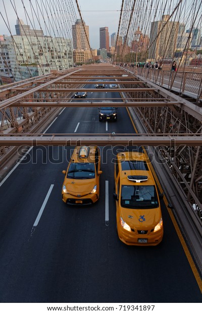 NEW YORK CITY, USA, September 11, 2017 : Traffic\
on Brooklyn Bridge. The Brooklyn Bridge is one of the oldest\
bridges in the US. It connects the boroughs of Manhattan and\
Brooklyn over the East\
River.