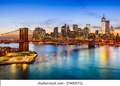 New York City, USA skyline over East River and Brooklyn Bridge.