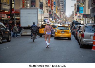 New York City, New York/ USA United States Of America - April 07 2019: Naked Cowboy, Famous NYC Street Performer On A Times Square Wearing Cowboy Boots, A Hat, White Briefs And Guitar. Editorial Use