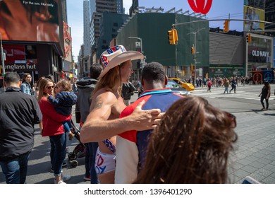 New York City, New York/ USA United States Of America - April 07 2019: Naked Cowboy, Famous NYC Street Performer On A Times Square Wearing Cowboy Boots, A Hat, White Briefs And Guitar. Editorial Use