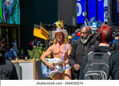 New York City, New York / USA United States - 04 07 2019: Naked Cowboy, Famous NYC Street Performer On A Times Square Wearing Cowboy Boots, A Hat, White Briefs And Guitar. Editorial Use